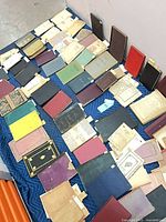 Overhead view of entire spread of books, notebooks and manuscripts on blanket