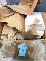 Cardboard box containing bundled loose papers and clippings