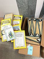 Stack of loose National Geographic magazines, motorcycle manual, dictionary, hardbound volume