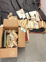 Closed cardboard box filled with books and wrapped newspaper clippings