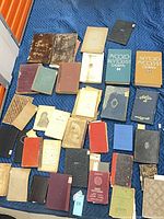 Top-down view showing full assortment of ~35 mixed vintage books