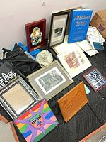 Overview of book, totes, caps, framed art, canvas painting, stand