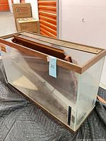 Full view of aquarium showing glass walls, wooden trim and interior condition