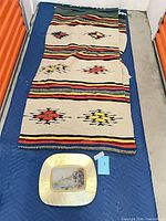 Overall view of runner rug and gilt plate on padded mat