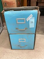 Front view of light blue two-drawer cabinet with label holders and handles