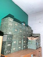 Stacked green marbled index card boxes on shelving
