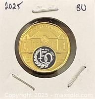 Reverse side of 2025 Supreme Court coloured loonie in 2x2 holder