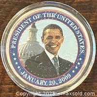 Obverse showing color portrait of Barack Obama, inscriptions and protective capsule
