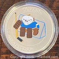Colour reverse of coin showing Quatchi goalie design and value