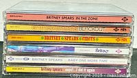 Stack of six Britney Spears CD albums showing spines