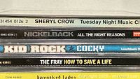 Spines of six CD cases showing album titles and artists