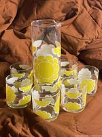 full set showing pitcher and six tumblers with yellow flower decals