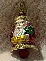 Full view of Santa bell ornament showing overall form, colors, hanger and clapper