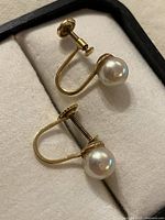 Front view of both earrings showing pearls and screw-back mechanism
