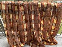 Panels draped over railing showing full pattern and drape