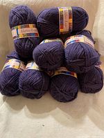 Eight skeins stacked showing colour and labels