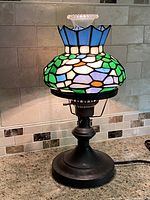 Lamp illuminated showing stained glass colors and base