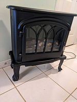 Front view of black electric stove heater with closed door
