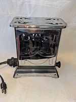 front view of chrome GE toaster with fold-down side panels