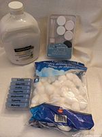 Full lot overview showing SpaSoap jug, travel bottle set package, cotton balls bag, pill organizer