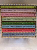 Spines of eight Little House paperbacks inside slipcase