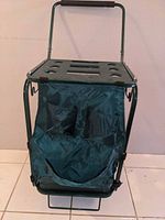 Front view of garden cart showing top tray slots and fabric bag