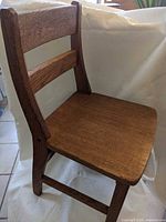 Front angled view of child's wooden chair