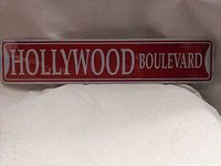 Front view of red Hollywood Boulevard metal sign