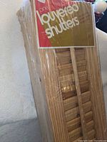 Bundle of pine louvered shutters in original plastic with label visible