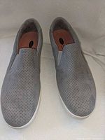 Top view of both grey slip-on sneakers