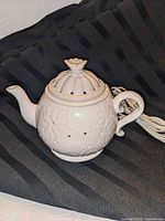 Overall view of ceramic teapot warmer showing floral design and lid