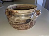 Side view showing glaze, handles, overall condition