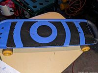 Top view showing grip tape pattern, wheels, trucks