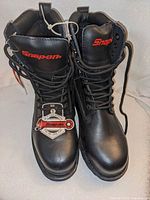 Front view of pair of black Snap-on safety boots with tags attached