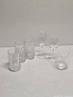Seven glass and crystal pieces displayed together
