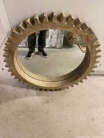 Front view of round wood gear-tooth mirror
