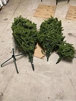 Three tree sections and stand laid out on floor