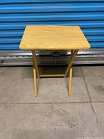 Front view of wooden folding TV tray table standing