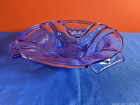 Angled side view blue glass dish showing color and rim design