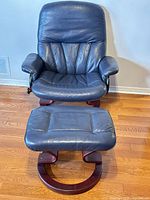 Front view of blue leather swivel chair and ottoman