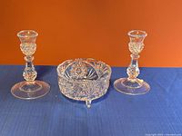 Full view of two candle holders and footed candy dish