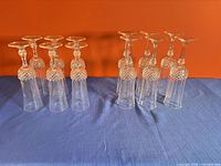 Twelve upside-down champagne flutes showing size groups and stem detail