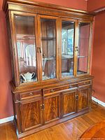 Full view of china cabinet showing upper glass hutch and lower storage base