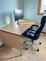 Desk with laminate top, metal pedestal drawers, monitor shown for scale