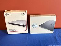 LG and Dell DVD writers in boxes side by side