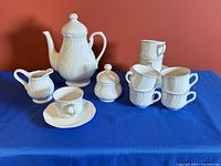 Full set arranged on table showing teapot, creamer, sugar bowl, teacups and saucers