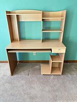 Front view of Ikea desk showing hutch, keyboard tray, drawer, and shelves