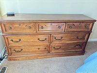 Front view of Kroehler seven-drawer dresser showing wood grain finish and hardware