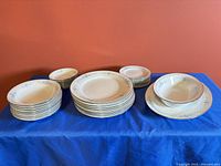 Full set showing stacked dinner plates, soup bowls, serving bowl and platter