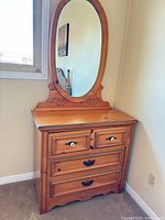 Front view of pine dresser with oval mirror